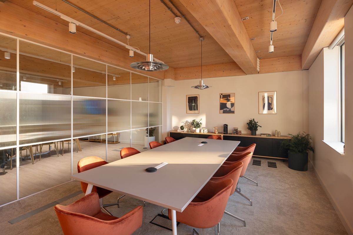 Meeting room with exposed timber ceiling, long white table and terracotta chairs – Technique by Buckley Gray Yeoman. Photograph by Daniel Avery.